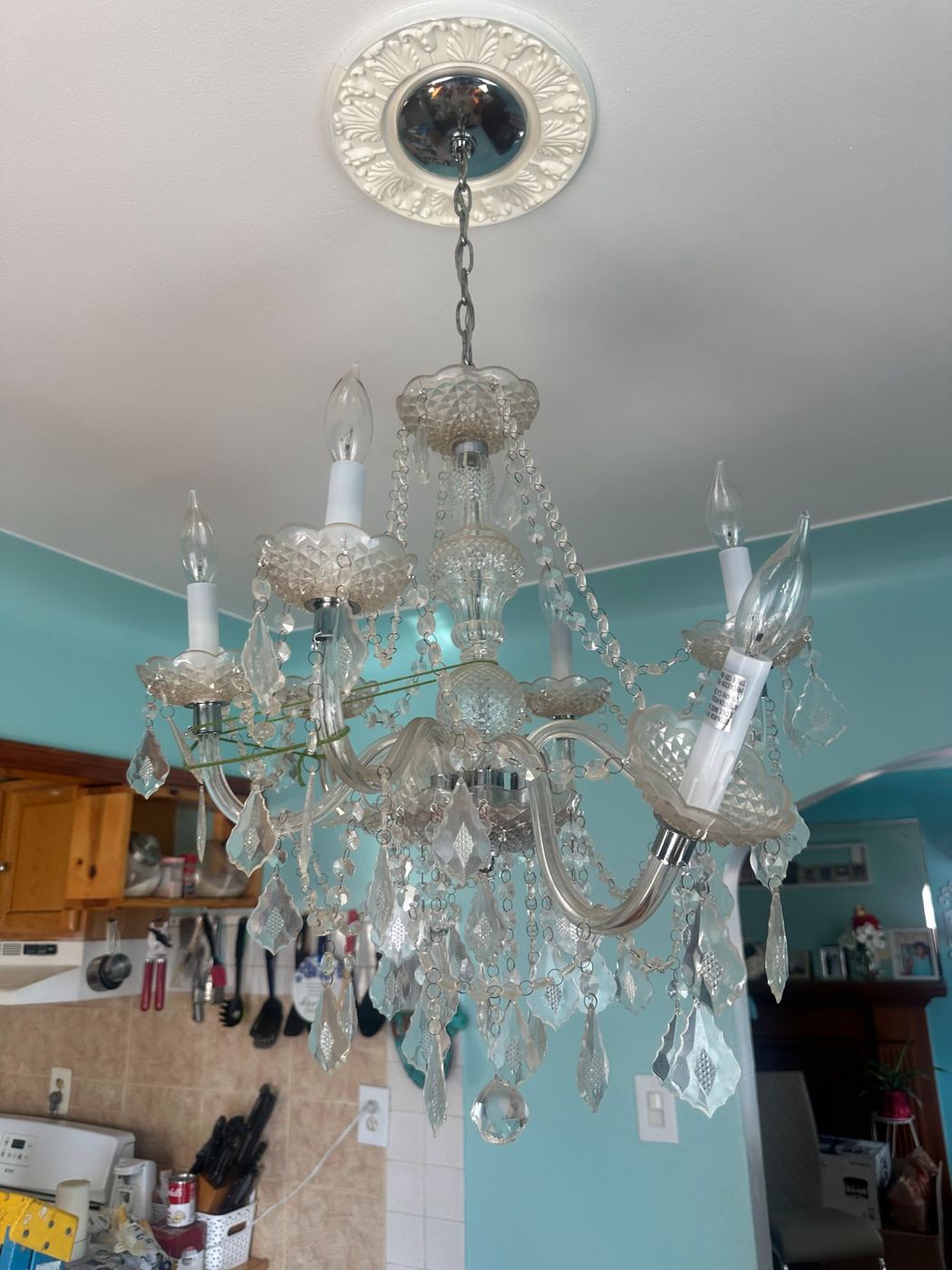 Damaged crystal chandelier with loose crystals before replacement