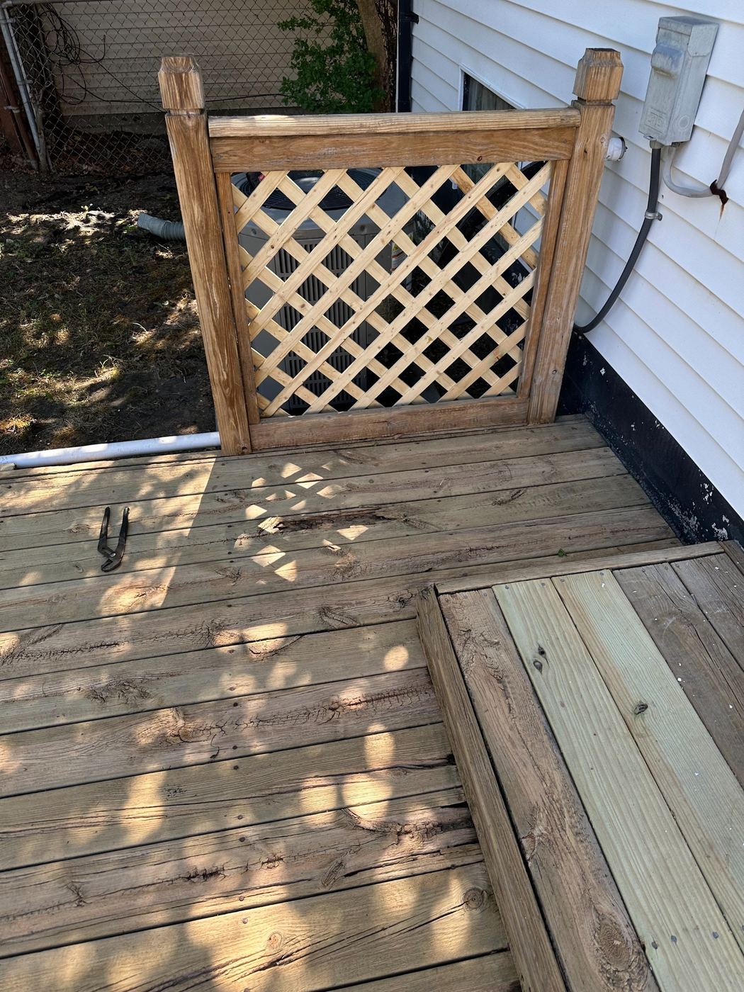 New wood lattice panel installed in a deck railing by SLY Residential